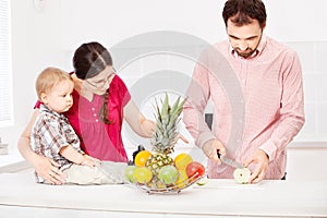 Father is preparing fruit for child