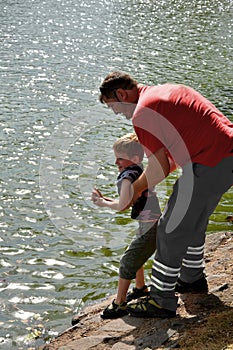 Man prevents a little boy from jumping into a river photo