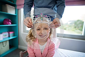 Father putting a tiera on daughters head
