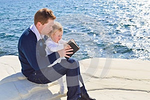 Father reading the Bible to his daughter