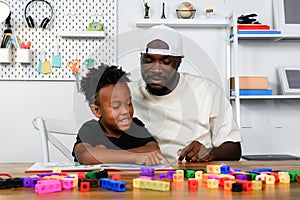 Father is Reading a Book to The Child. The Father is Helping The Child Develop Their Language Skills and Imagination. Father