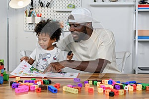 Father is Reading a Book to The Child. The Father is Helping The Child Develop Their Language Skills and Imagination. Father