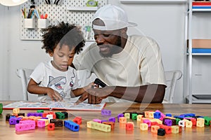 Father is Reading a Book to The Child. The Father is Helping The Child Develop Their Language Skills and Imagination. Father