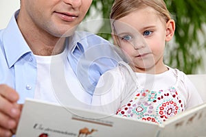 Father reading daughter a story