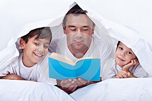 Father reading to his sons