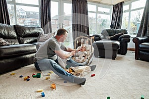 Father Relaxing at Home with his Baby Daughter