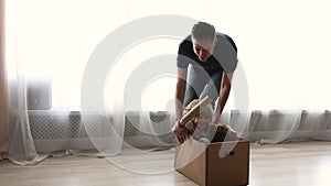 Father riding son while he sitting inside of cardboard box