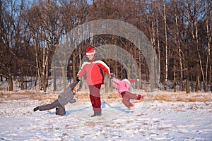 Father rotate children in winter photo