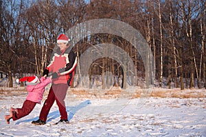 Father rotate daughter in winter photo