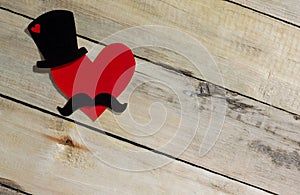 Father`s Day background. Black hat, mustache and red heart.