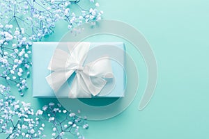 Father`s day background, blue background with white flowers and a present.