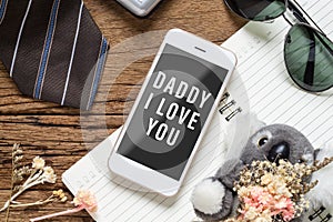 Father`s day background concept. Mock up mobile phone for your artwork with Father`s accessories items and daughter`s toy on wo