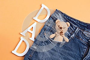 Father`s Day background with toy bears in a jeans pocket.