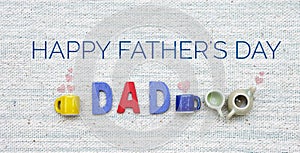 Father`s day banner with Dad letter and coffee cup and tea pot on canvas fabric texture background