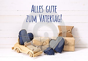 Father`s Day card with wooden toy car, gift boxes and denim hear