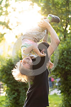 Father`s day celebration. Fatherhood, parenthood, childhood, caring, summer and leisure concept - young dad with beard