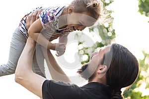 Father`s day celebration. Fatherhood, parenthood, childhood, caring, summer and leisure concept - young dad with beard