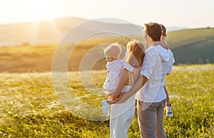 Father`s day. child daughter sits on her dad shoulders outdoors