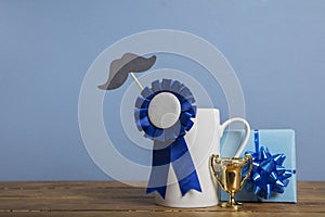 Father's day coffee mug with blue rosette award. Happy father's day concept