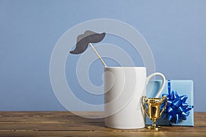 Father's day composition with gifts, coffee mug and paper mustache