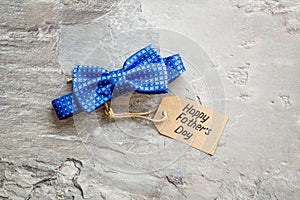 Father`s Day concept with bow tie on grey background top view copy space