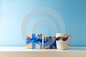 Father`s day concept with coffee cup, mustache and gift box over blue background