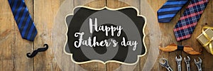 Father`s day concept. gift box, tie and funny moustache over wooden background. top view, flat lay. banner