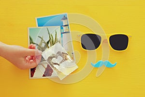 Father& x27;s day concept. Hipster yellow sunglasses and funny moustache next to photographs