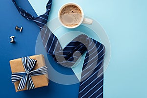 Father`s Day concept. Top view photo of craft paper gift box with silk ribbon bow blue tie cup of frothy coffee and cufflinks on