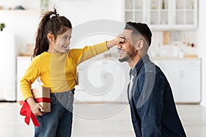 Father's Day. Cute Little Daughter Greeting Arab Dad With Holiday At Home