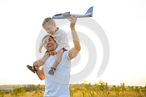 Father& x27;s day. dad and baby son playing together outdoors plane