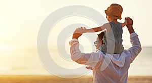 Father`s day. Dad and baby son playing together outdoors on a su