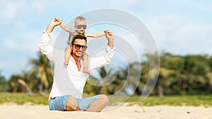 Father`s day. Dad and baby son playing together outdoors on a su