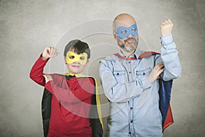 Father`s day,father and son dressed as a superhero