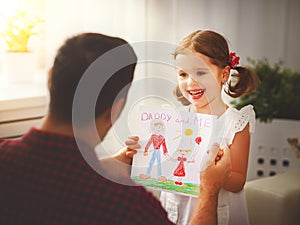 Father`s day. Happy family daughter giving dad greeting card