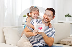 Father`s day. Happy family daughter giving dad greeting card