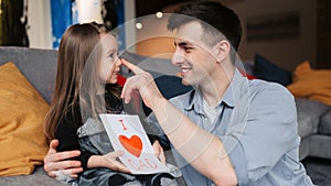 Father\'s day. Happy family daughter giving dad a greeting card on holiday