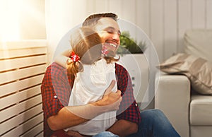 Father`s day. Happy family daughter hugging dad and laughs