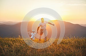 Father`s day. Happy family father and toddler son playing and la