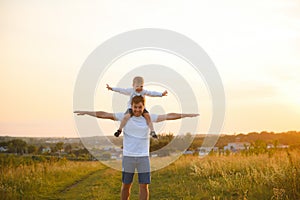 Father's day. Happy family father and toddler son playing and laughing on nature at sunset