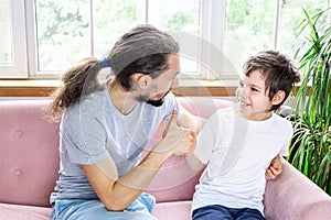 Father`s day. Happy funny family dad and son spending their time together. A loving father encourages his son. Family