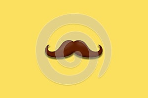Father\'s Day. Mustache on a yellow background close-up