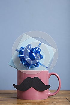 Father`s day present with a coffee mug and paper mustache