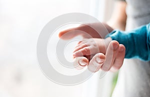 Father`s hand gently holding his child s hand