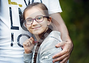 Father`s hand hugs daughter