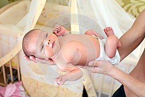 Father's hands holding his newborn baby boy