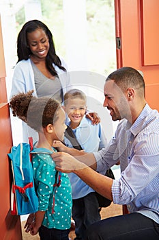 Father Saying Goodbye To Children As They Leave For School