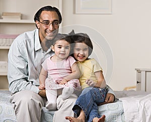 Father Sitting with Daughters