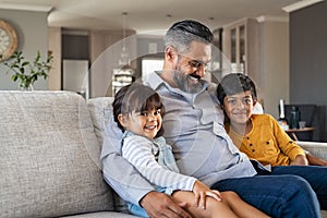 Father sitting with kids on couch