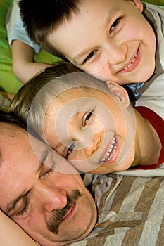 Father Sleeps While Sons Smile